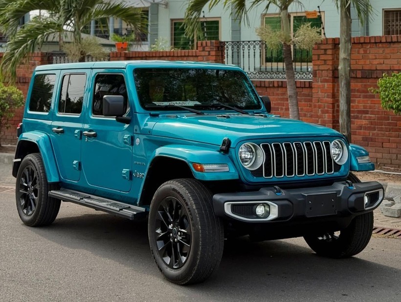 Hình ảnh chiếc Jeep Wrangler màu xanh lam đỗ trên địa hình đất