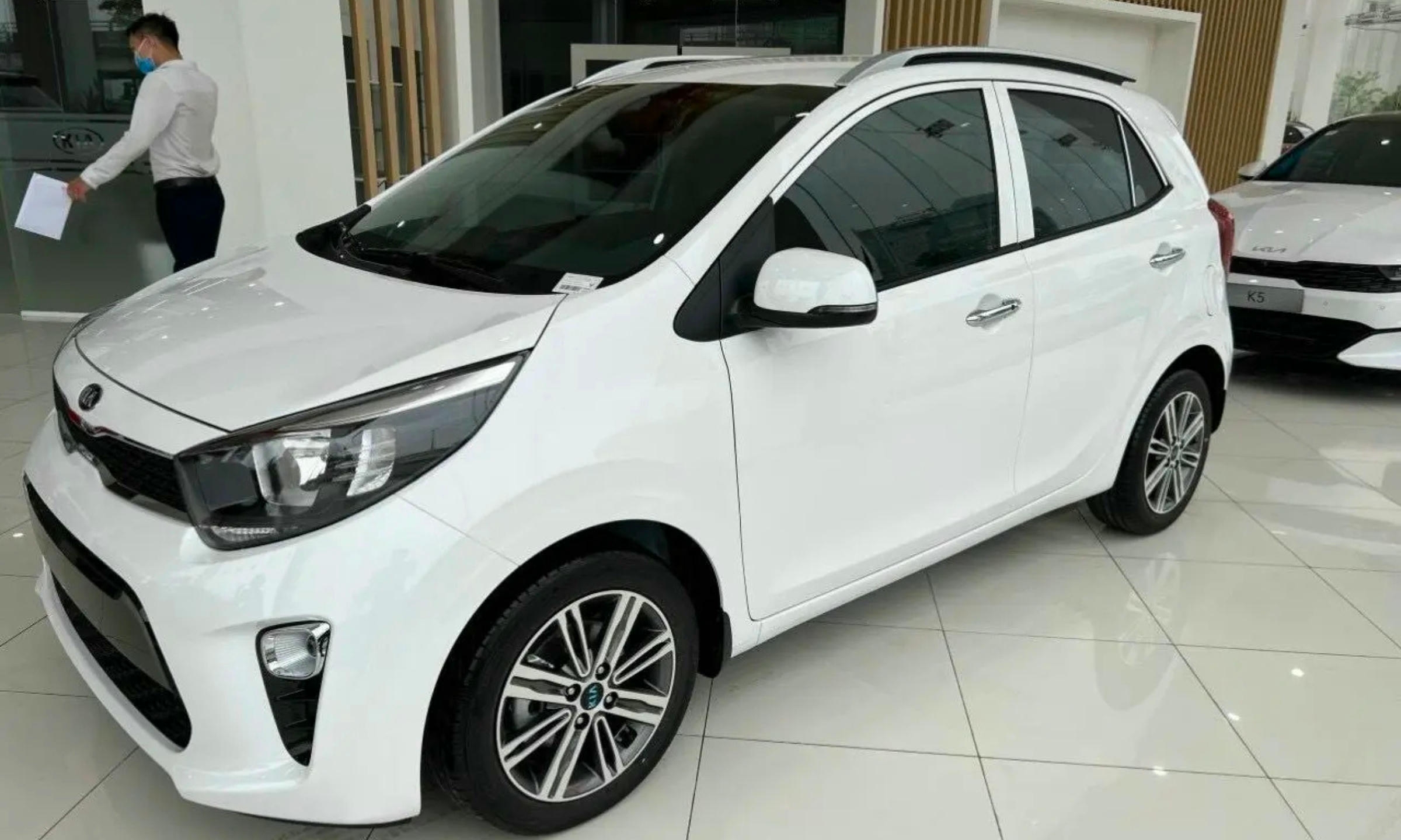 Kia Morning màu trắng đỗ trên đường phố