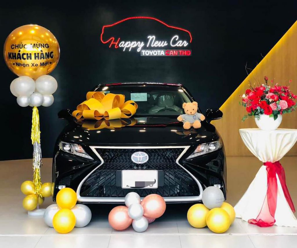 Nơ giao xe ô tô màu đỏ trang trí trên xe Toyota tại sự kiện